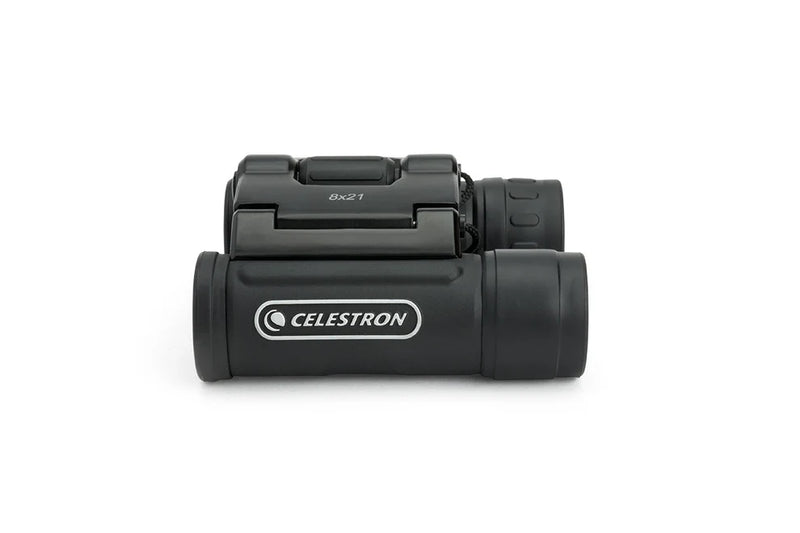 Celestron UpClose G2 8x21 roof binoculars with compact design and black body, displayed in box with product name and branding.