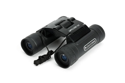 Celestron UpClose G2 10x25 roof binoculars with compact black design, featuring adjustable eyepieces and a sturdy carrying case.