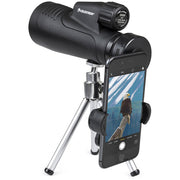 Celestron Outland X 20x50 binoculars with tripod and adapter, showing the compact design and adjustable eyepieces.