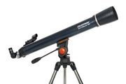 Celestron AstroMaster 90AZ refractor telescope set up outdoors with tripod and optical tube, ready for stargazing.