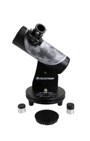Celestron FirstScope Telescope from the Moon Signature Series showing the telescope and its accessories in a natural setting.