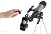 Celestron Travel Scope 70 DX portable telescope with backpack and smartphone adapter, ideal for outdoor astronomical viewing.