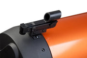 Celestron StarPointer finderscope mounted on telescope, compact accessory for easy sky navigation and star locating.