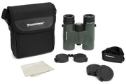 Celestron Nature DX 10x32 roof binoculars with black body and silver accents, showing close-up of eyepieces and focus wheel.