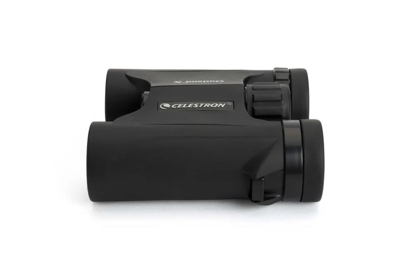 Celestron Outland X 8x25 Roof Binoculars shown from the side, compact black design with textured grip and lens details.