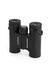 Celestron Outland X 10x25 roof binoculars showing compact design and textured grip for outdoor wildlife viewing.