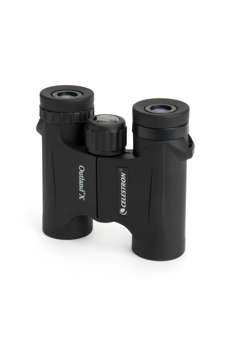 Celestron Outland X 10x25 roof binoculars showing compact design and textured grip for outdoor wildlife viewing.