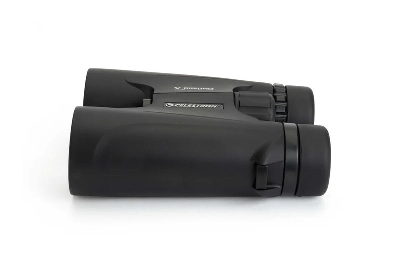 Celestron Outland X 10x42 roof binoculars with black body and textured grip, side view showing lenses and branding.