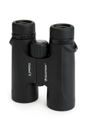 Celestron Outland X 10x42 roof binoculars with black body, standing upright, showing the eyepieces and central focusing wheel.