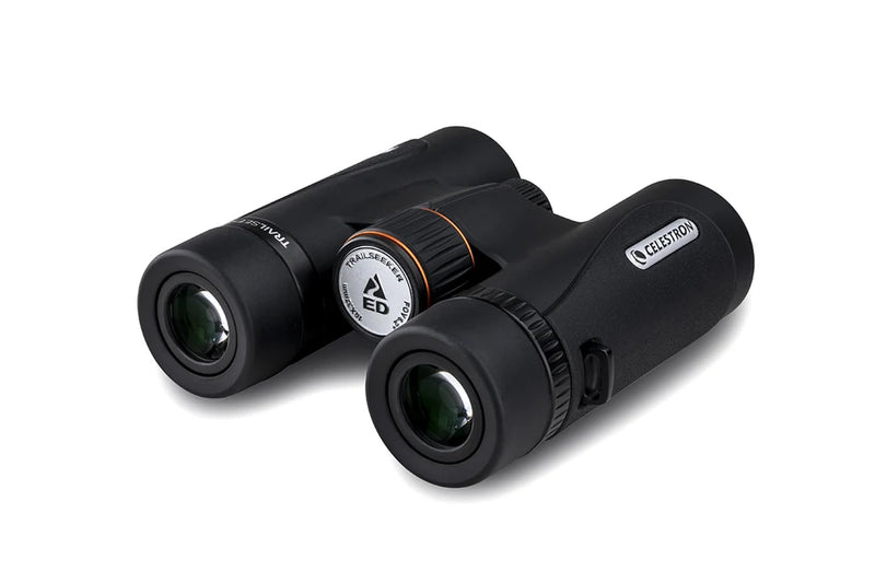 Celestron TrailSeeker ED 10x32 roof binoculars showing close-up of the black and silver binoculars with textured grip and lens details.