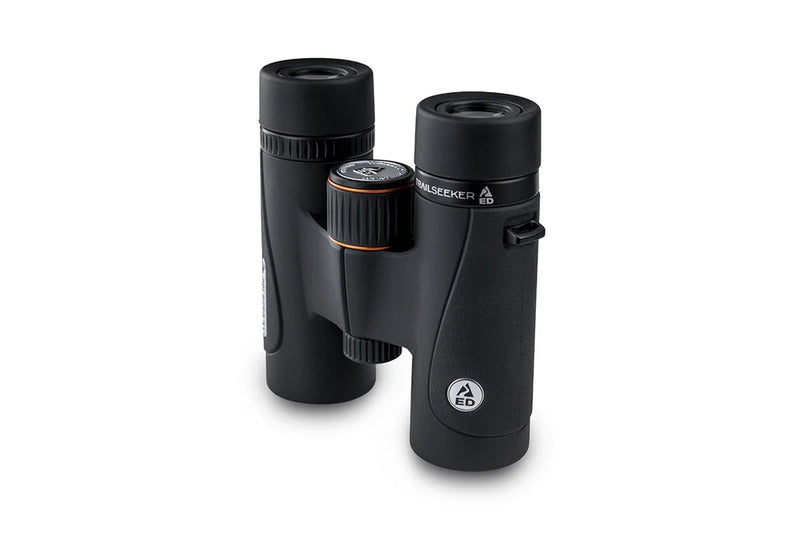 Celestron TrailSeeker ED 10x32 roof binoculars showing the compact design, eyepieces, and textured focus wheel for outdoor viewing.