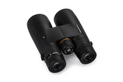 Celestron Nature DX black 10x50 roof binoculars showing the compact design and textured grip for outdoor wildlife viewing.