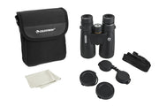 Celestron Nature DX 10x50 ED roof binoculars showing close-up of the binoculars with textured grip and objective lenses.