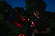 Celestron Night Vision Red Headlamp with adjustable strap and red LED light for hands-free illumination during outdoor activities.