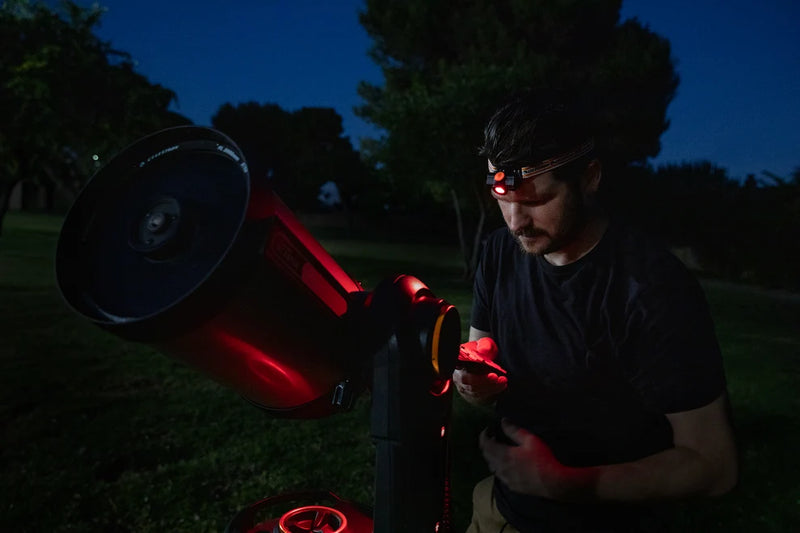 Celestron Night Vision Red Headlamp with adjustable strap and red LED light for hands-free illumination during outdoor activities.