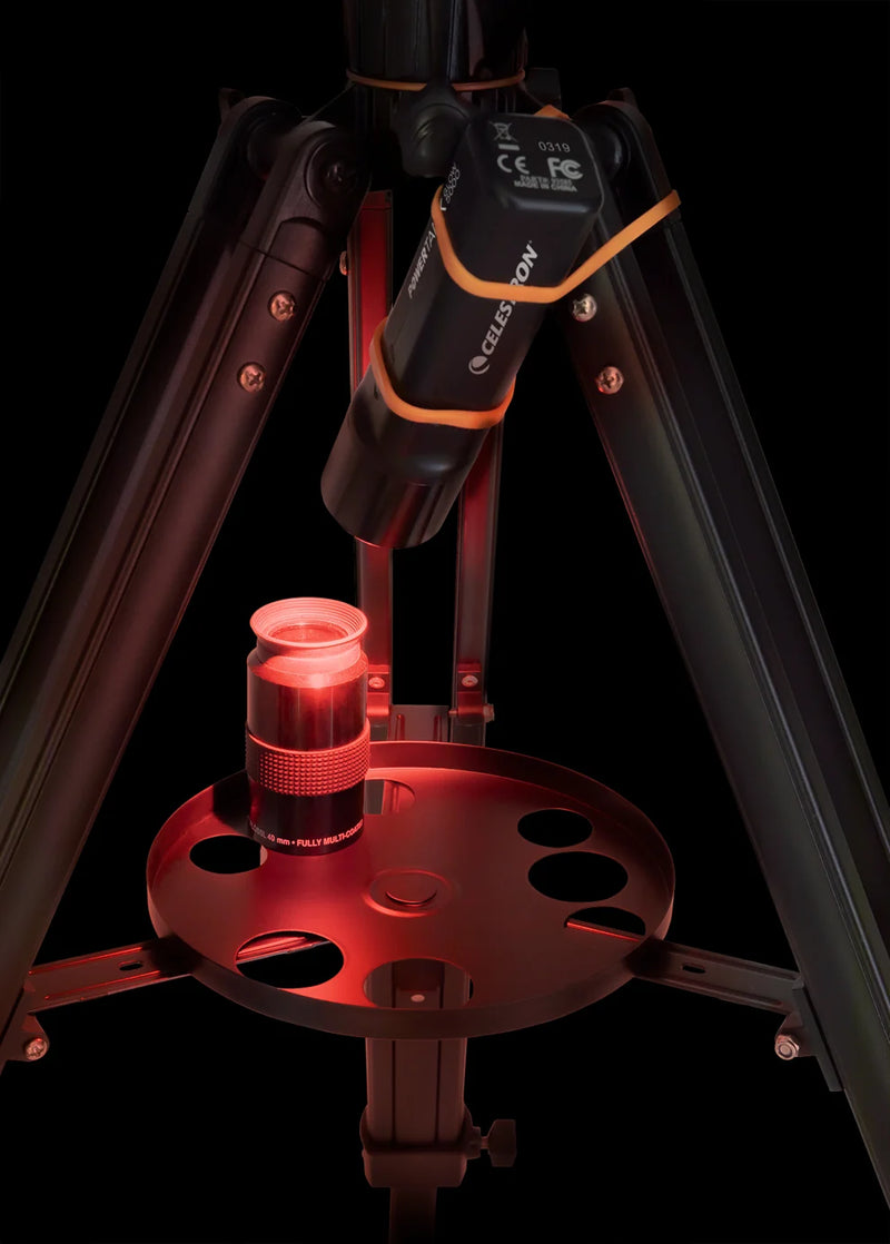 Celestron PowerTank Glow 5000 red flashlight and portable charger, compact accessory with glow-in-the-dark features.