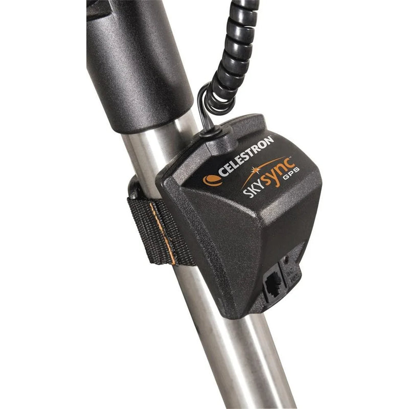 Celestron SkySync GPS accessory for astronomy telescopes, showing the compact device with connection ports and branding.