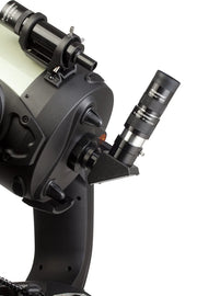 Celestron 2-inch eyepiece and filter kit with various lenses and filters for telescope accessories, mounted for viewing.